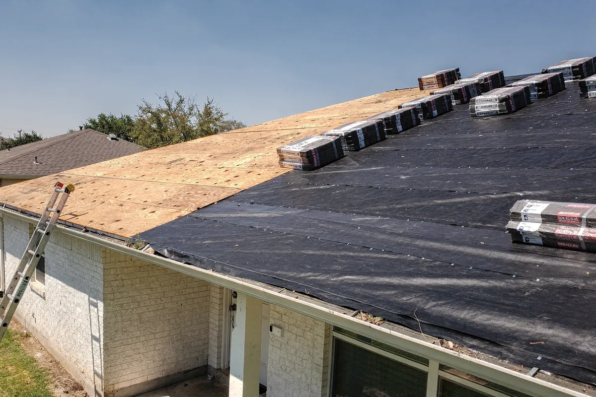 A Texas roof stripped to the deck with underlayment partly laid